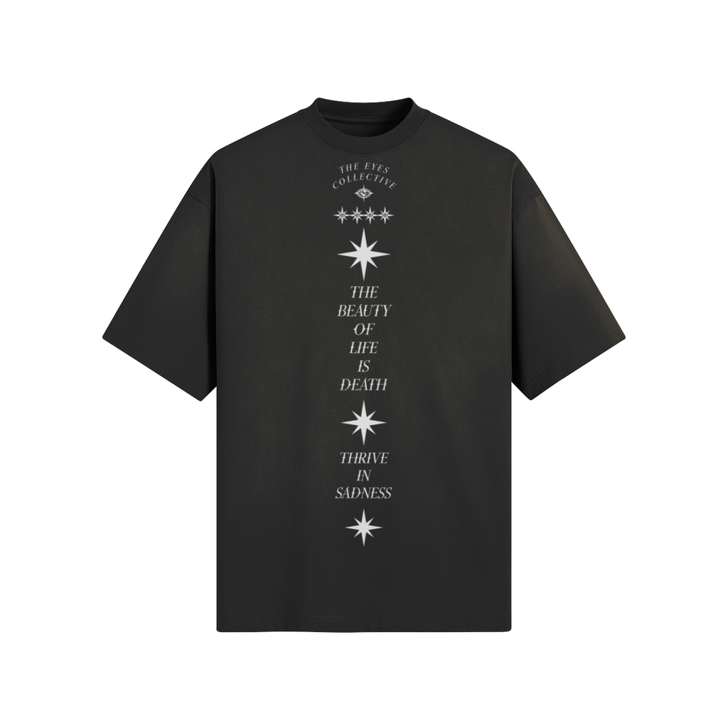 Alternate front view of the Sad Times Tee showing THE EYES COLLECTIVE mark, star motifs, dropped shoulders and washed black finish.